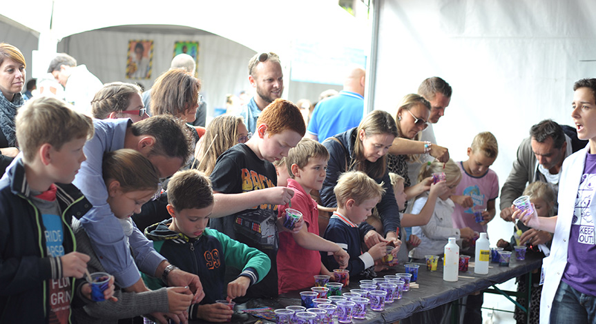 Kids at a table making slime in a cup